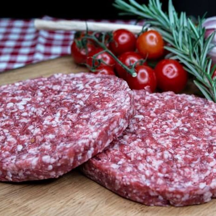 Angus Burger Patties auf Holzbrett